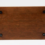 Cherry wood end grain cutting board with rich warm wood tones. Displaying a view of the bottom side with four cutting board feet.