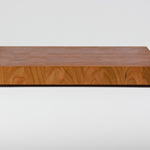 Cherry wood end grain cutting board with rich warm wood tones, rear view.