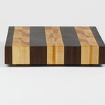 Luxurious Black Walnut and Maple cutting board, side view.