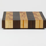 Luxurious Black Walnut and Maple cutting board, side view.
