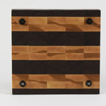 Luxurious Black Walnut and Maple cutting board, bottom view, displaying four cutting board feet.