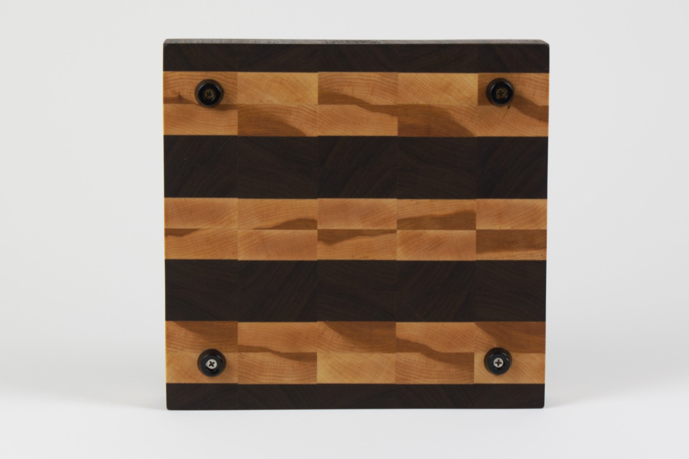 Luxurious Black Walnut and Maple cutting board, bottom view, displaying four cutting board feet.