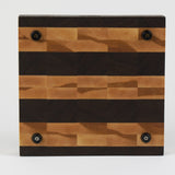 Luxurious Black Walnut and Maple cutting board, bottom view, displaying four cutting board feet.