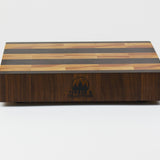 Luxurious Black Walnut and Maple cutting board, front view, displaying the Timber & Tradition logo.