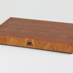 Cherry wood end grain cutting board with rich warm wood tones.  Timber & Tradition logo burned into center front. Front right corner view