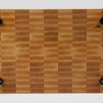 Classic Hard Maple cutting board with golden hues, straight on view of the bottom surface.  Four cutting board feet mounted to this surface.