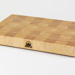 Classic Hard Maple cutting board with golden hues. The Timber & Tradition logo is burned into the center front, this is the front right corner view.