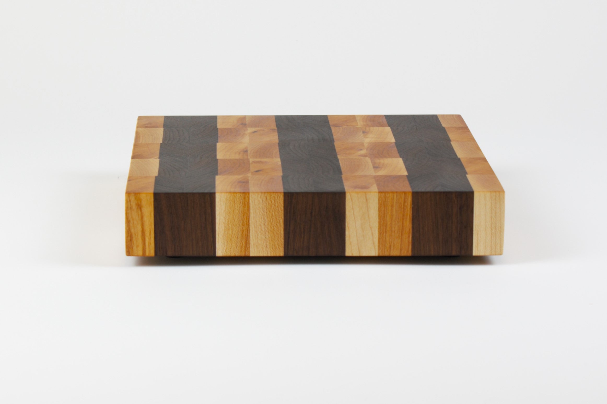 Luxurious Maple and Black Walnut cutting board, side view.