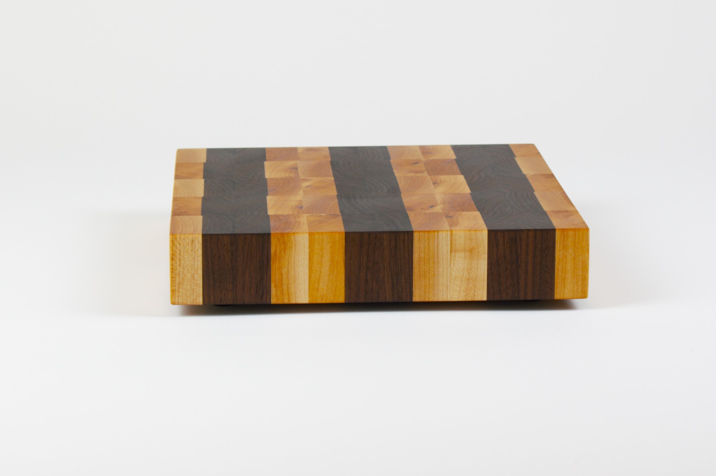 Luxurious Maple and Black Walnut cutting board, side view.