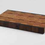 End grain cutting board made of rustic Hard Maple and accented with Tigerwood and Black Walnut. Front right corner view.