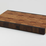 End grain cutting board made of rustic Hard Maple and accented with Tigerwood and Black Walnut. Front right corner view.