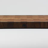 End grain cutting board made of rustic Hard Maple and accented with Tigerwood and Black Walnut. Front center view with the Timber & Tradition logo burned into front of board.