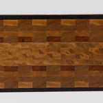 End grain cutting board made of rustic Hard Maple and accented with Tigerwood and Black Walnut. Straight on view of the cutting surface.